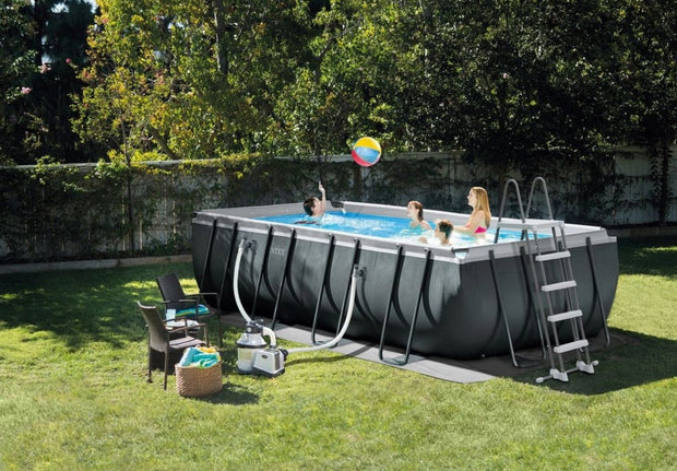Gezin met kinderen speelt met strandbal in Intex Ultra XTR Frame rechthoekig opzetzwembad van 549x274x132 cm in de tuin, met zichtbaar zandfilterpomp en veiligheidsladder