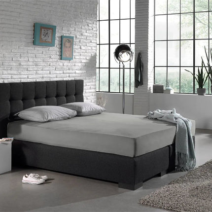 Grijs The Living Store hoeslaken op een boxspring in de slaapkamer
